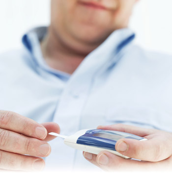 photo of man using blood glucose meter