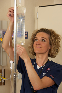 nurse hanging iv bag